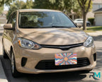 colorful retro vanity plate on chocolate car — boho sunburst front license plate