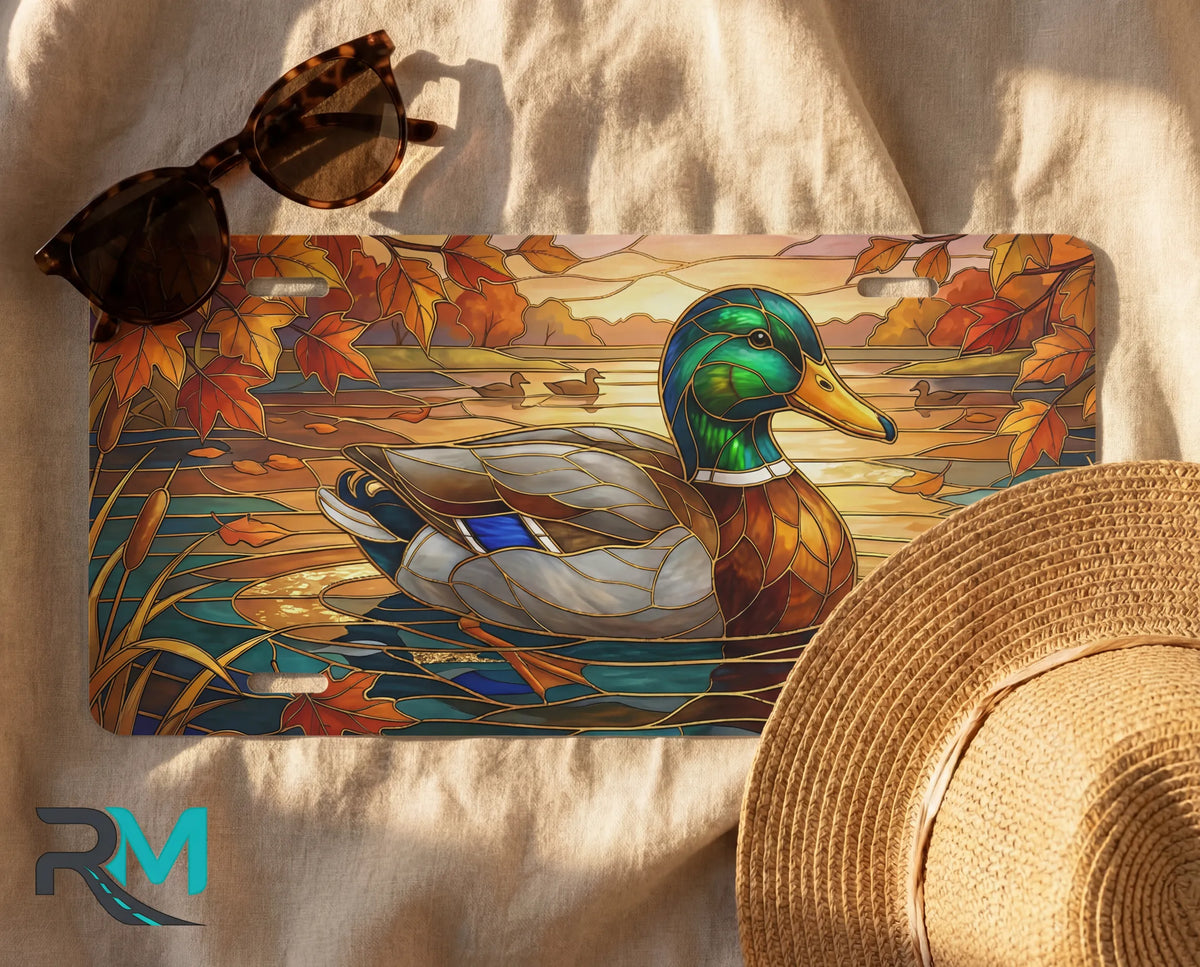 mallard duck license plate flat lay — emerald mallard amber autumn leaves pond front plate