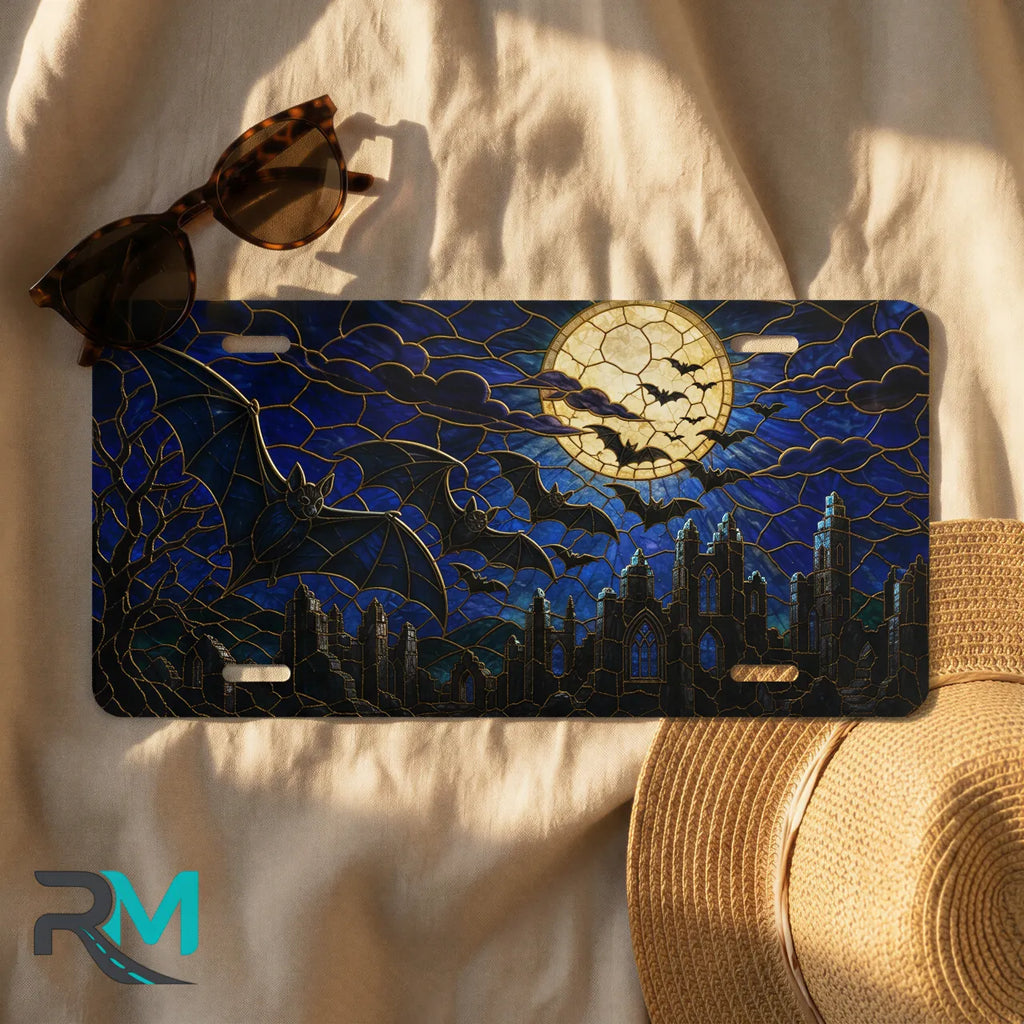 full moon bats license plate flat lay — midnight blue bat silhouette cracked moon city front plate