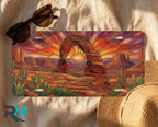 desert arch sunset license plate flat lay — warm amber sandstone arch cactus burning sunset front plate