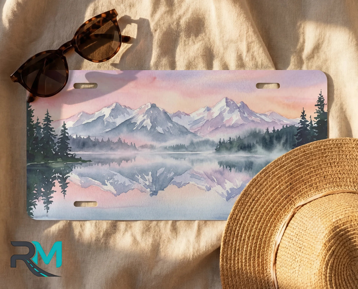decorative mountain lake license plate flat lay — soft lavender pink alpine front license plate