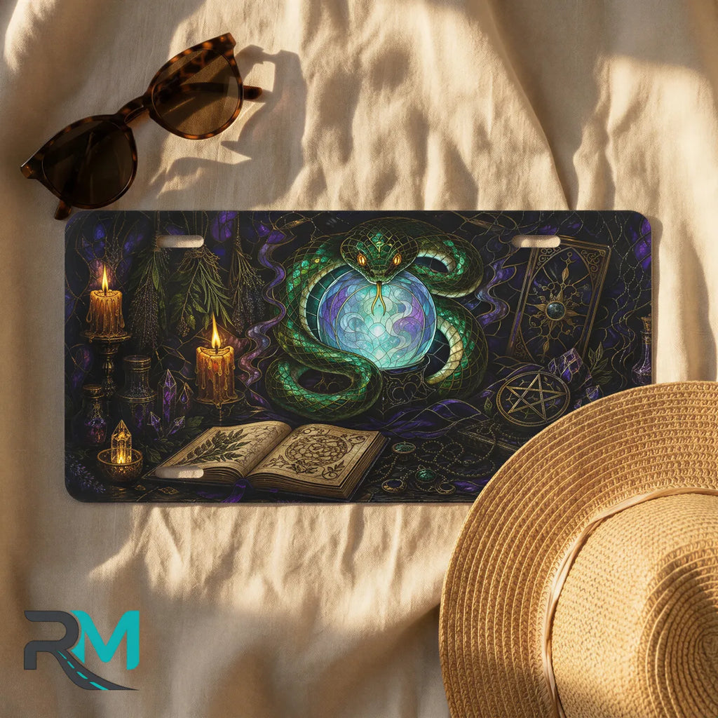 green serpent crystal ball license plate flat lay — jewel green serpent glowing orb candles front plate