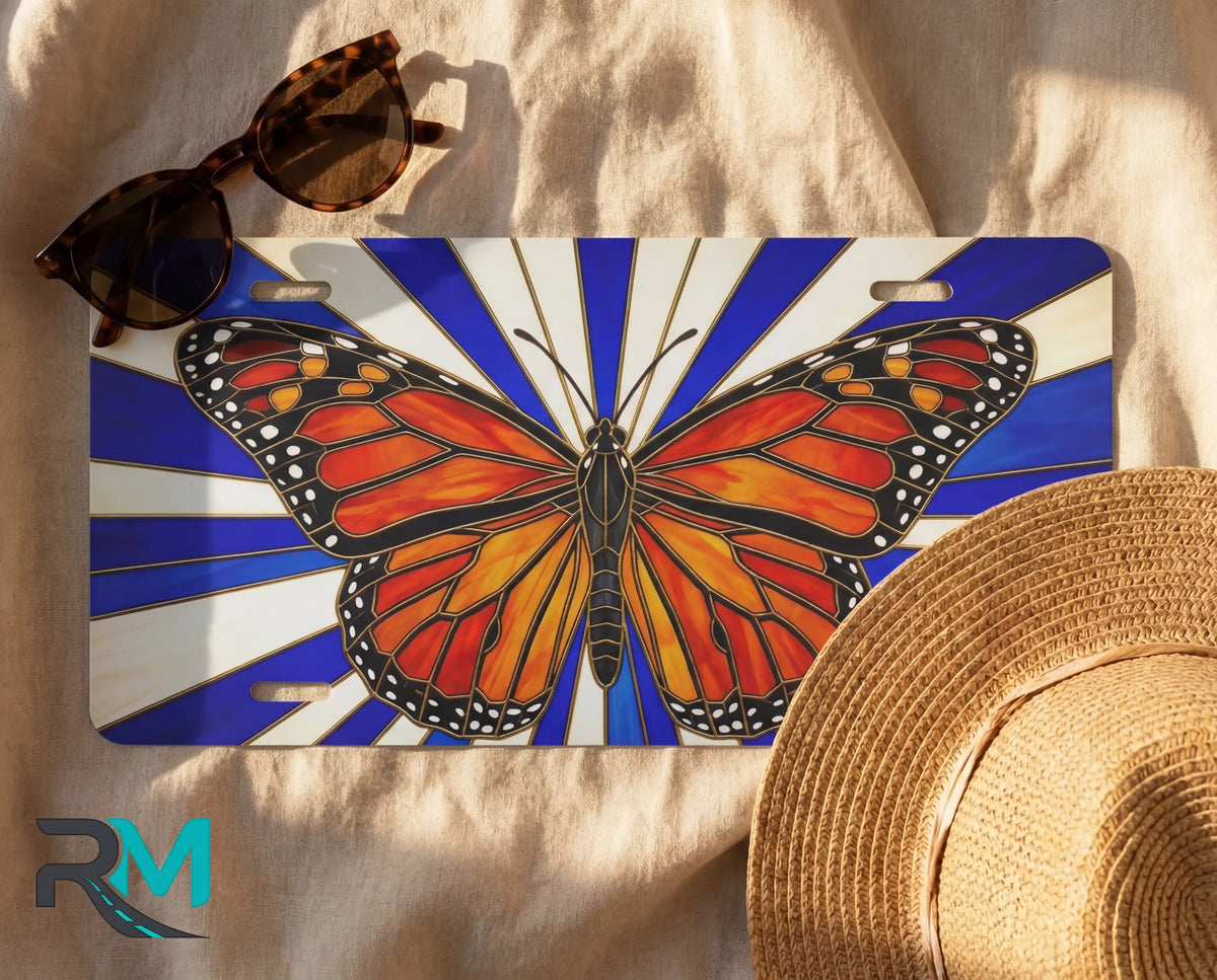 butterfly nature license plate flat lay — monarch orange black blue cream front license plate
