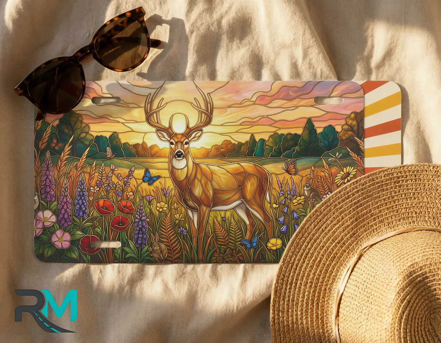deer meadow license plate flat lay — warm amber buck wildflower meadow front license plate