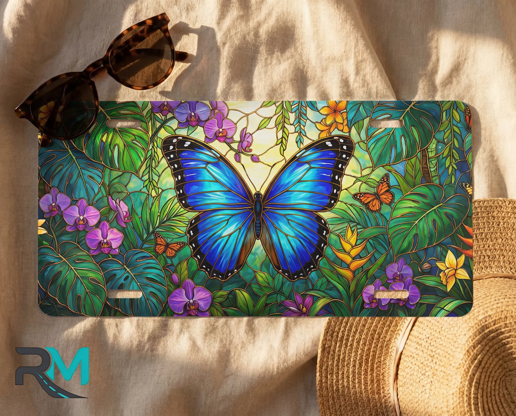 blue butterfly license plate flat lay — vivid sapphire blue butterfly tropical foliage front plate