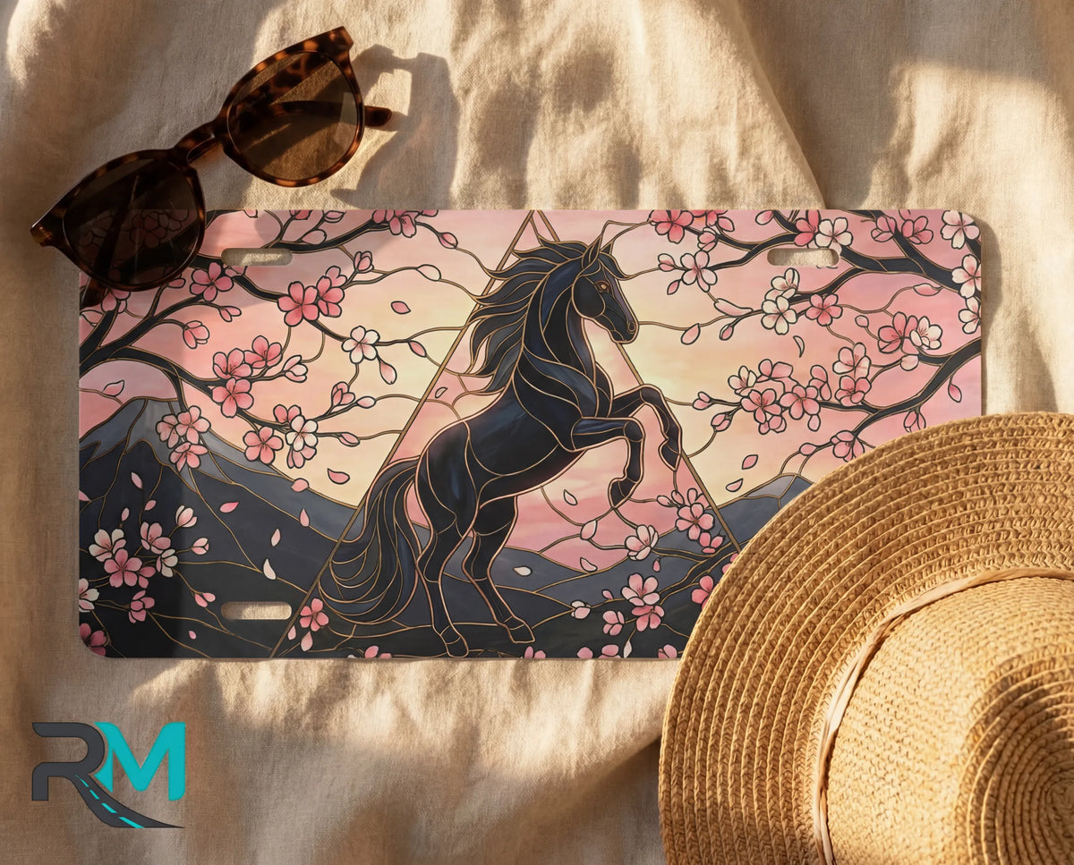 black unicorn cherry blossoms license plate flat lay — midnight black unicorn blush pink front plate