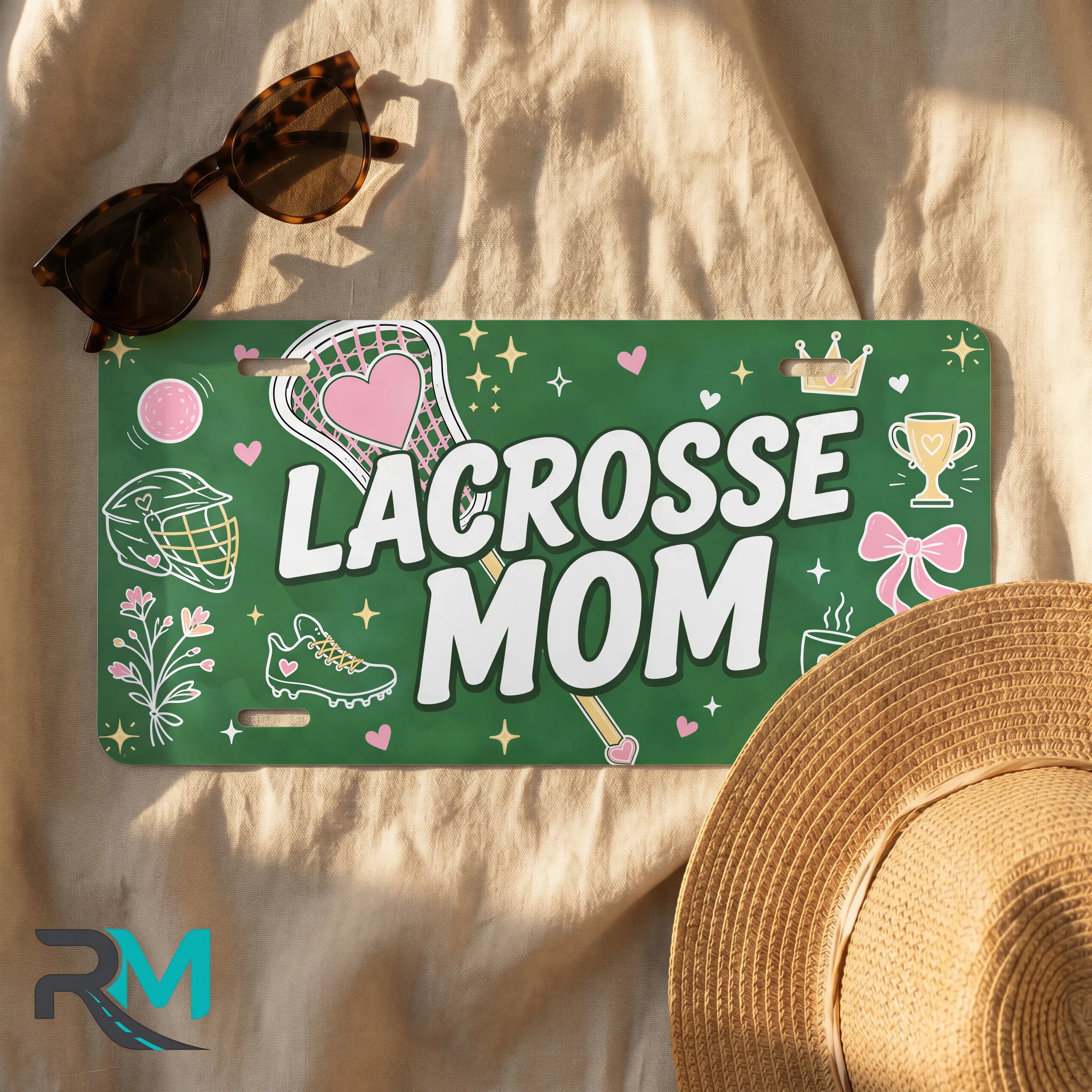 lacrosse mom license plate flat lay — deep green pink lacrosse sticks front plate