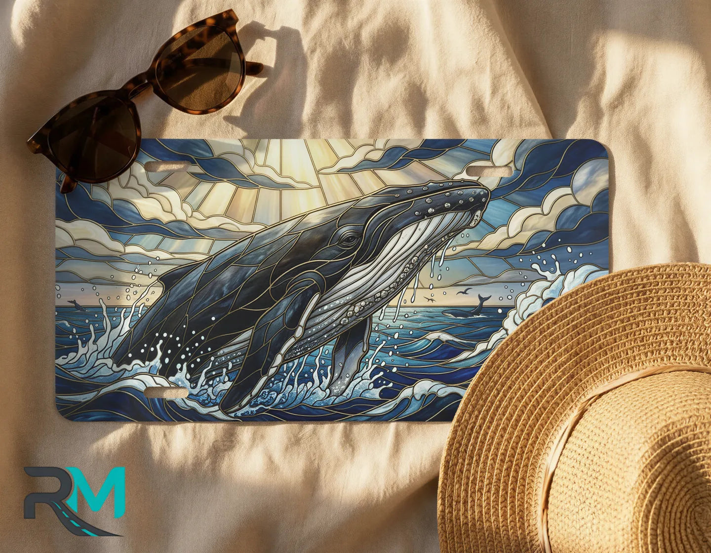 whale surfacing license plate flat lay — deep blue gold breaching whale front license plate