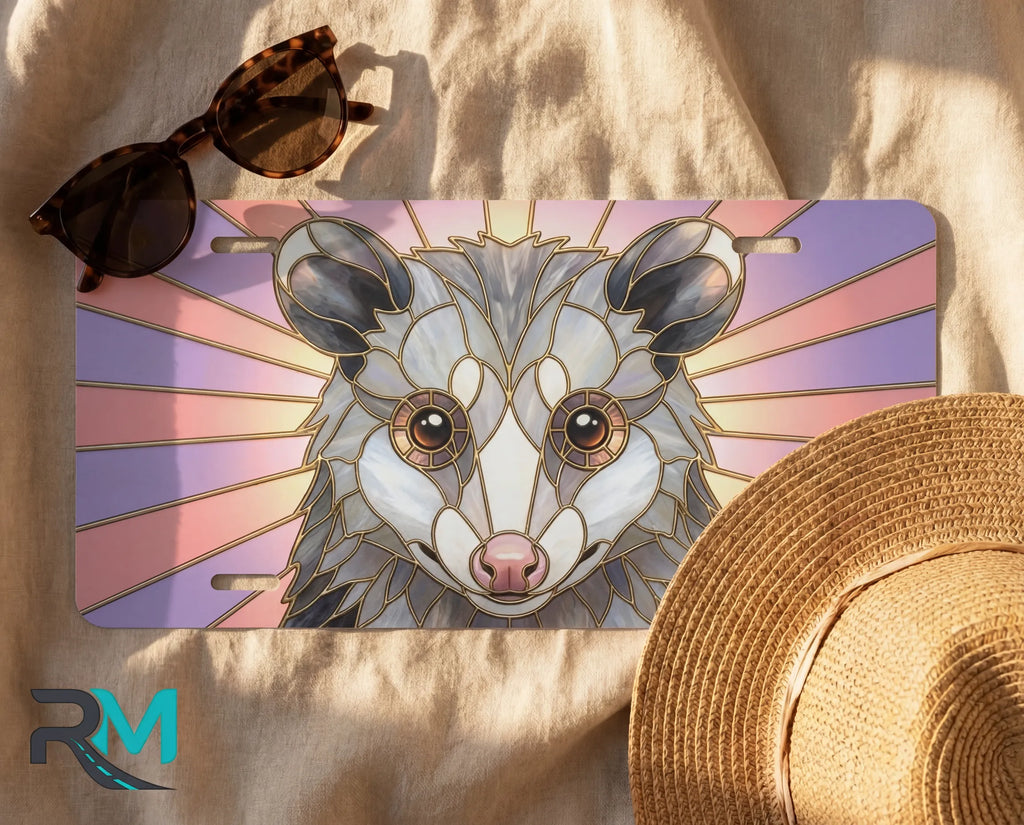 opossum vanity plate flat lay — pastel pink lavender stained glass possum front license plate