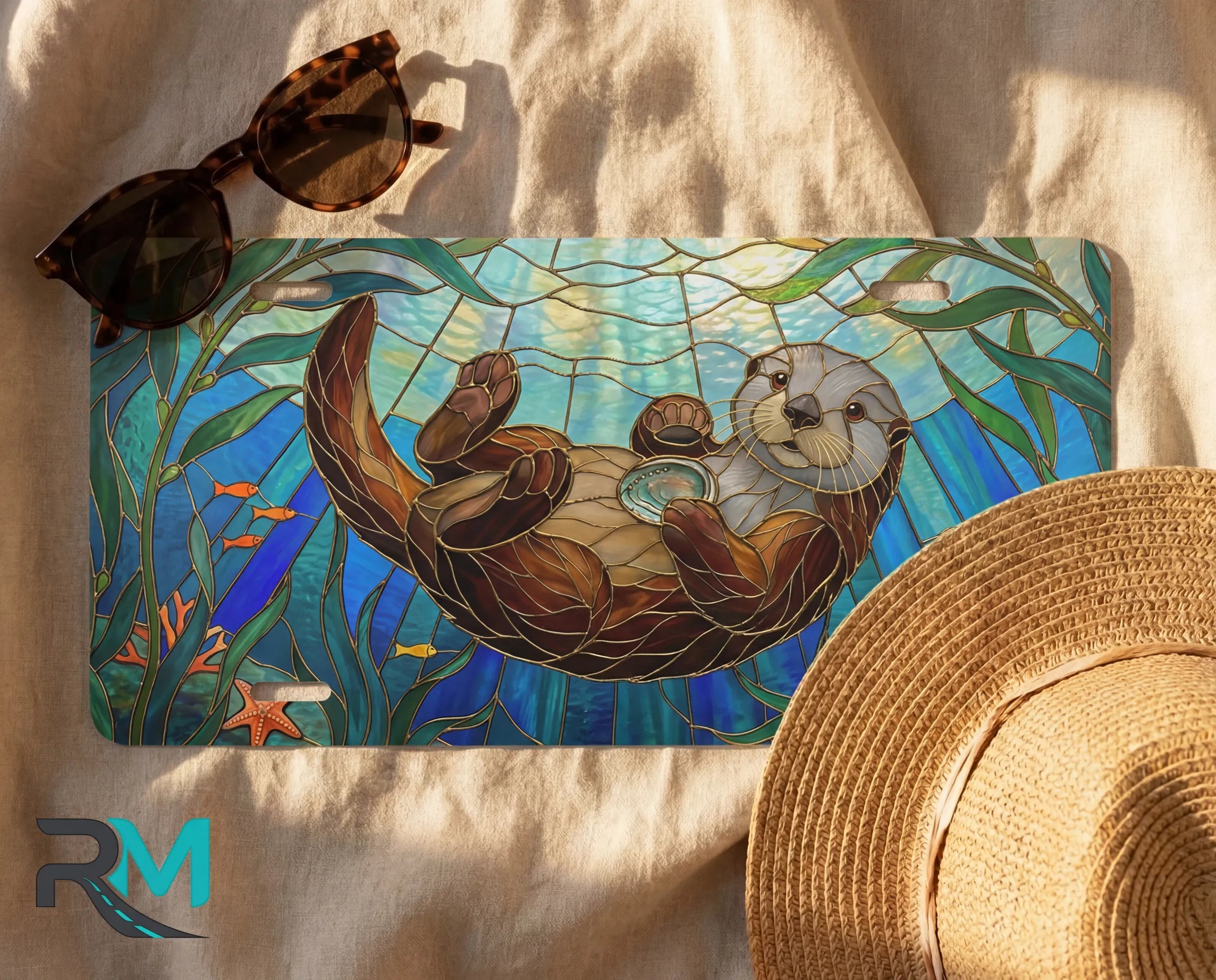 sea otter stained glass license plate flat lay — jewel teal otter kelp sunbeam front plate