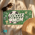 soccer mom license plate flat lay — pink soccer ball green cleats trophy front plate