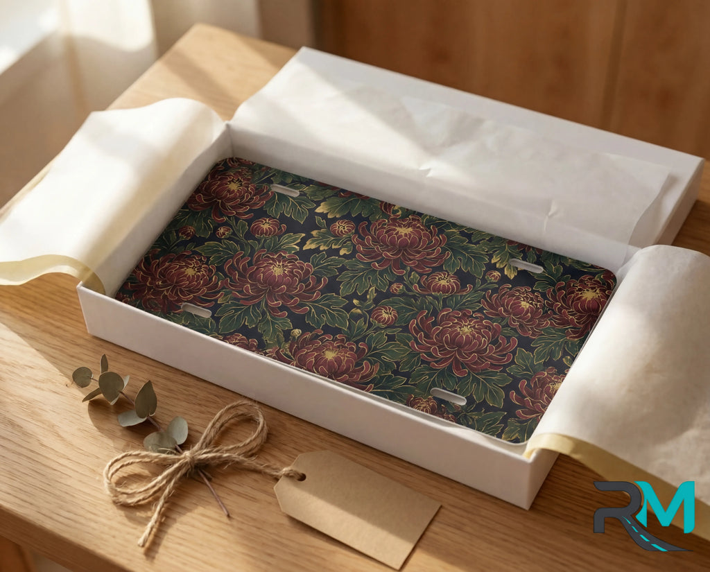 vintage floral chrysanthemum license plate flat lay — deep burgundy chrysanthemums lush green leaves antique front plate