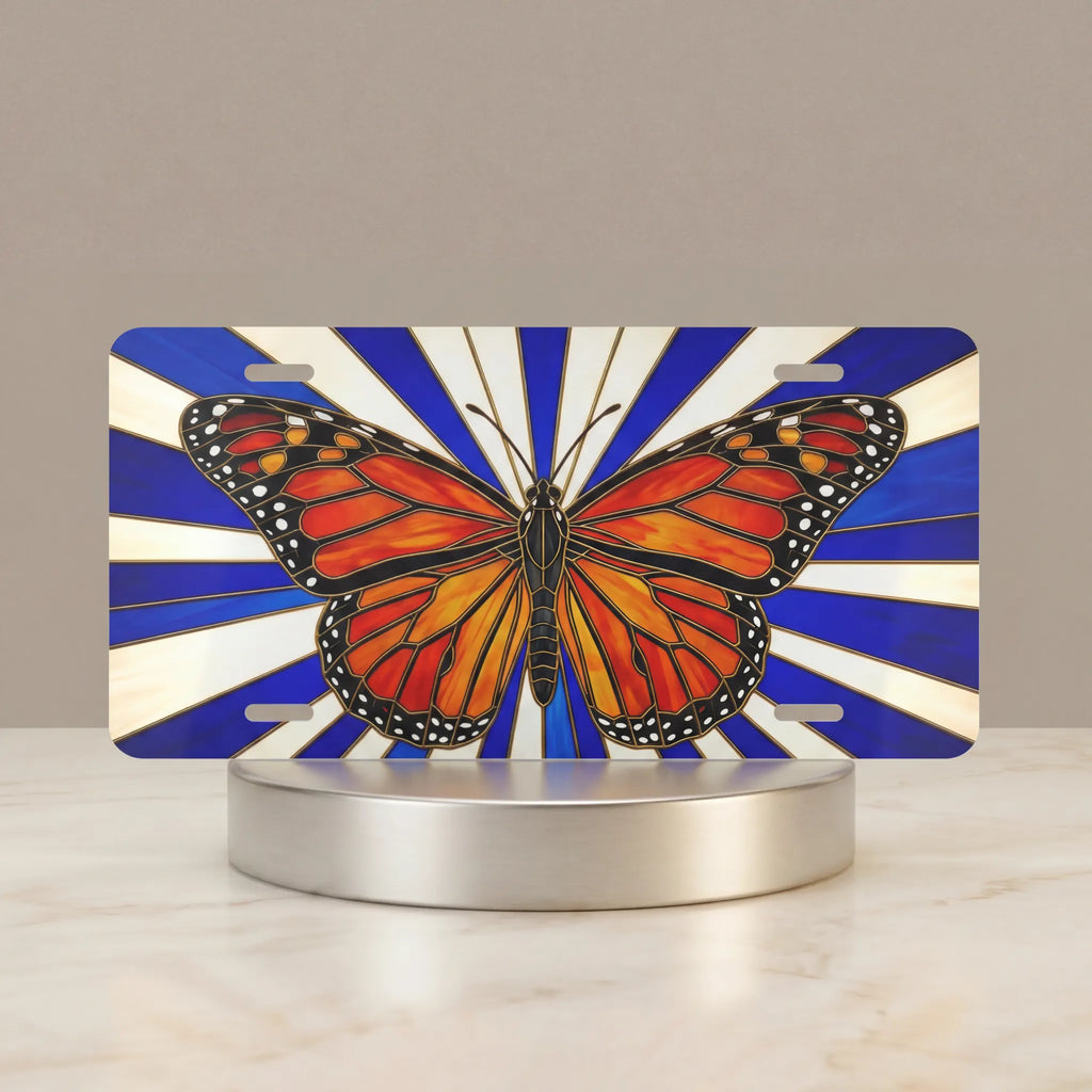 monarch butterfly vanity plate hero shot — jewel-toned orange wings blue sunburst art