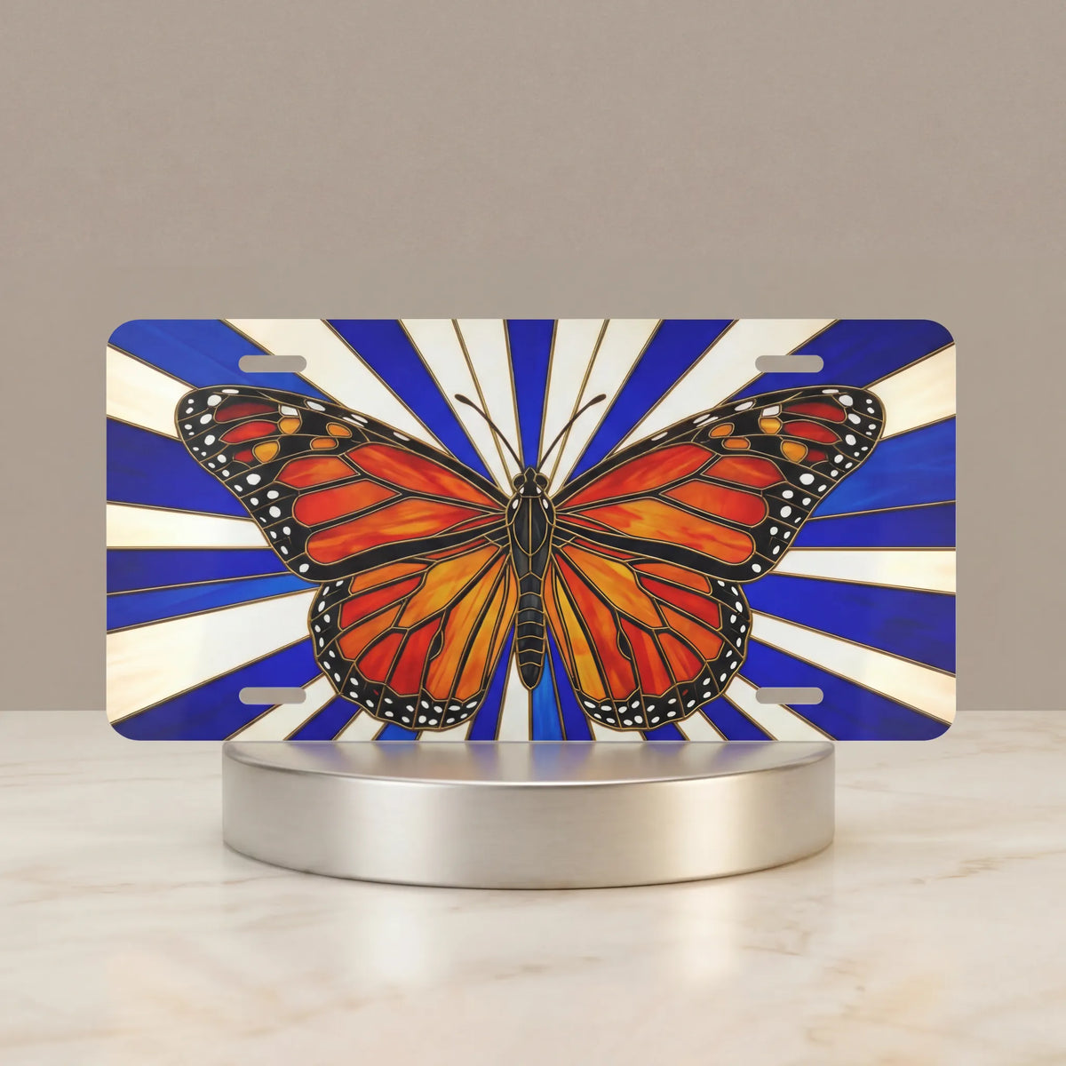 monarch butterfly vanity plate hero shot — jewel-toned orange wings blue sunburst art