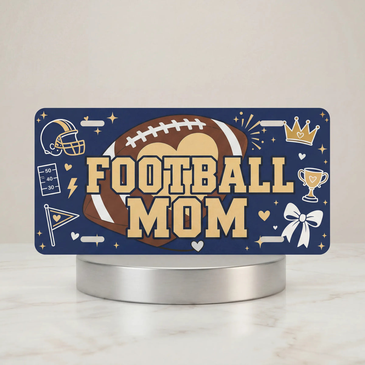 football mom vanity plate — deep navy leather football helmet FOOTBALL MOM license plate on holder