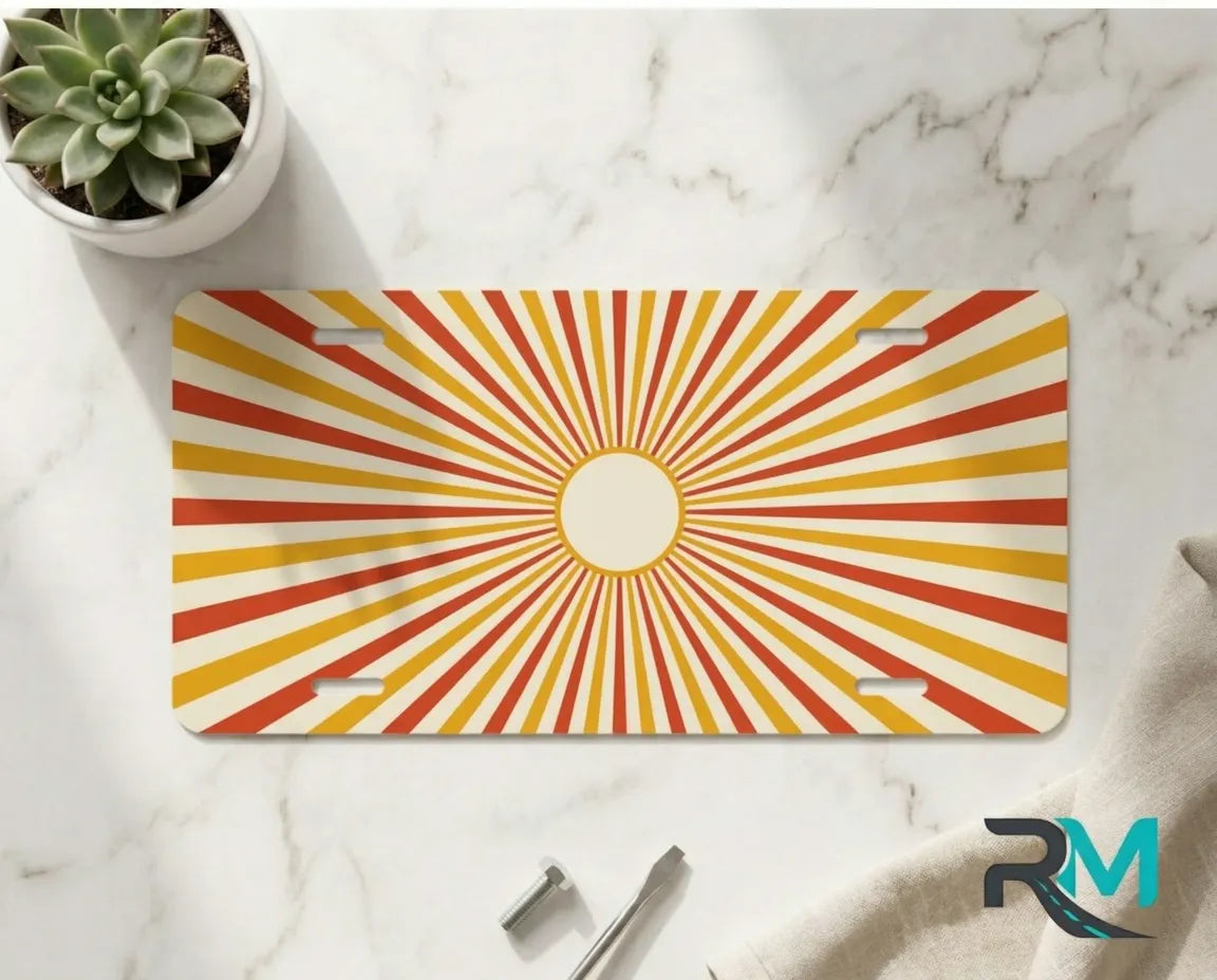 orange yellow radiant vanity plate on marble surface — vivid retro sunburst decorative plate