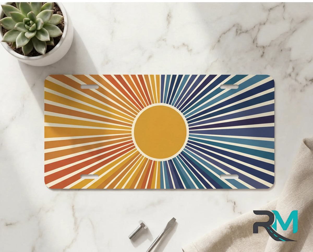 indigo sunrise front license plate on marble surface — retro twilight sunburst decorative plate