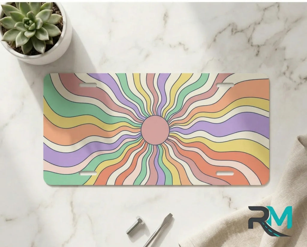 pastel sunburst vanity plate on marble surface — dreamy candy rainbow decorative license plate