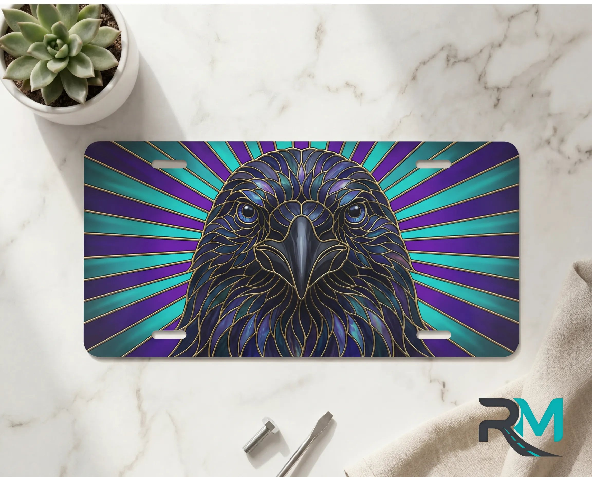 raven radiant rays vanity plate on marble surface — jewel-tone bird decorative license plate