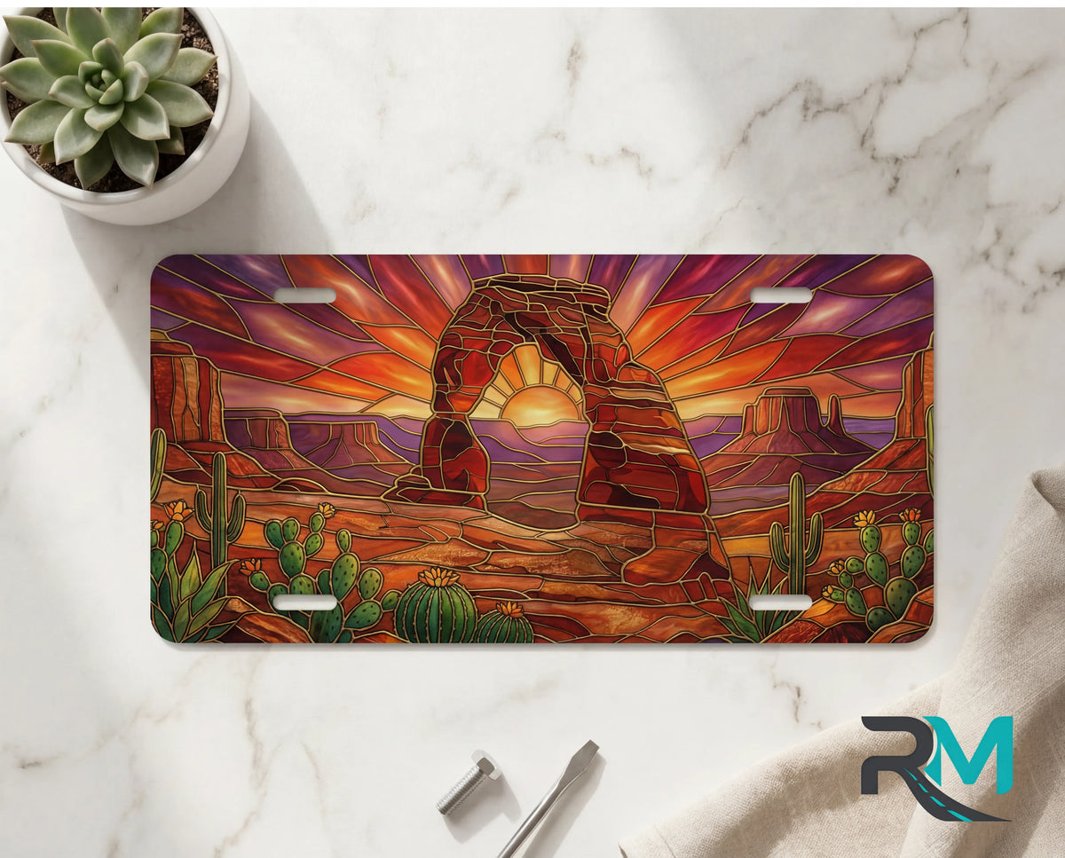 desert arch sunset vanity plate on marble surface — warm amber sandstone arch cactus decorative plate