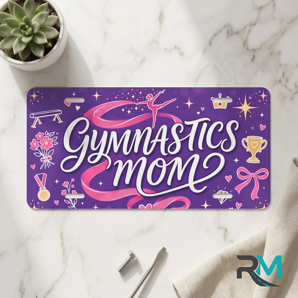 gymnastics mom vanity plate on marble surface — purple pink ribbon decorative license plate