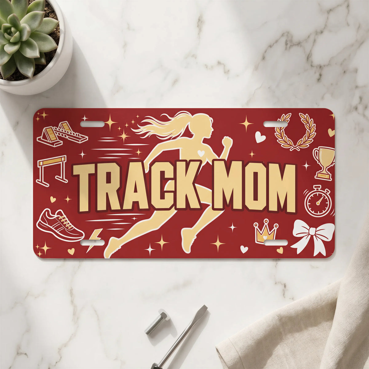 track mom vanity plate on marble surface — runner silhouette decorative license plate