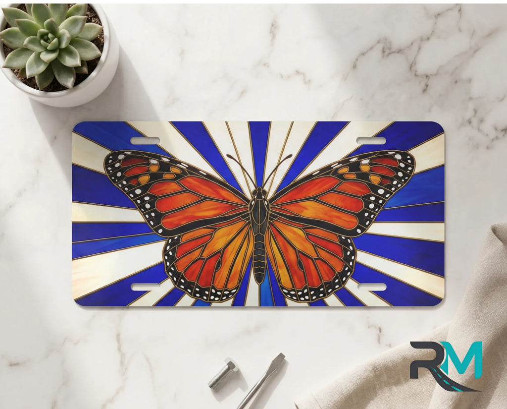 monarch butterfly vanity plate on marble surface — vivid orange wings blue ray decorative plate