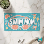 swim mom vanity plate on marble surface — teal coral goggles decorative license plate