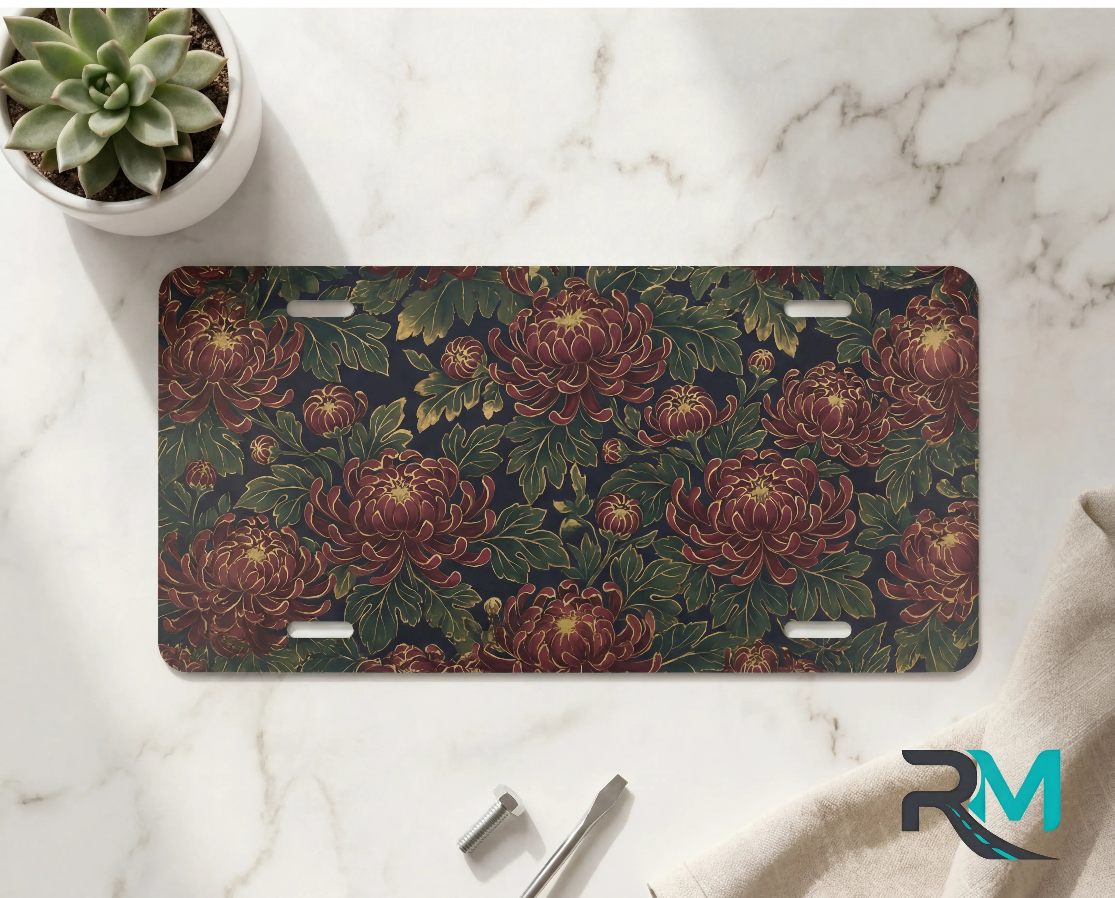 vintage floral chrysanthemum vanity plate on marble surface — deep burgundy chrysanthemums lush green decorative plate