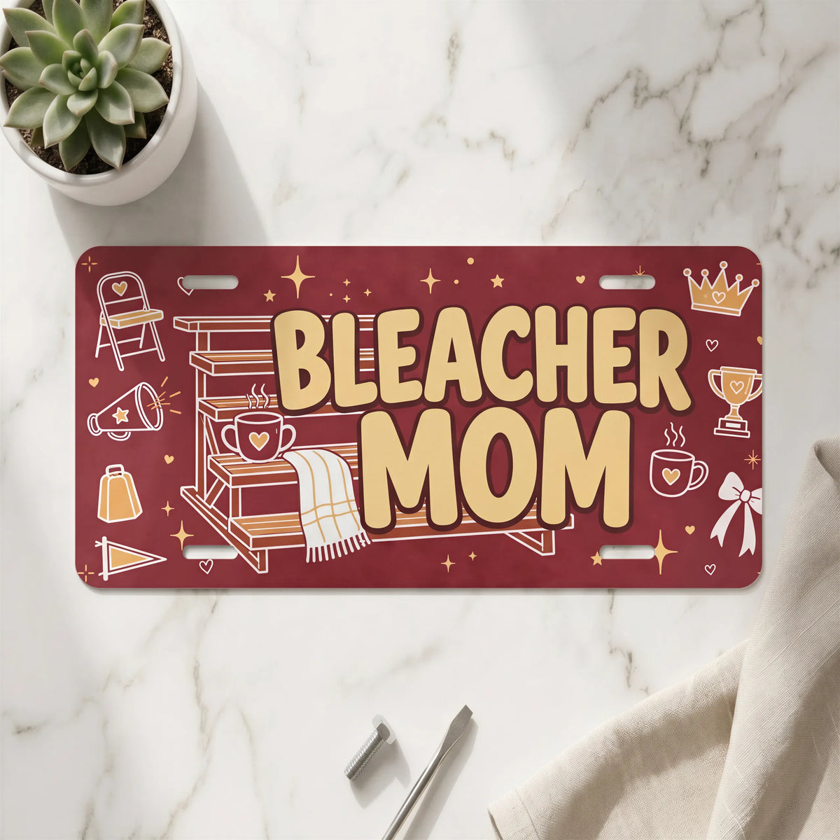 bleacher mom vanity plate on marble surface — maroon folding chair decorative plate