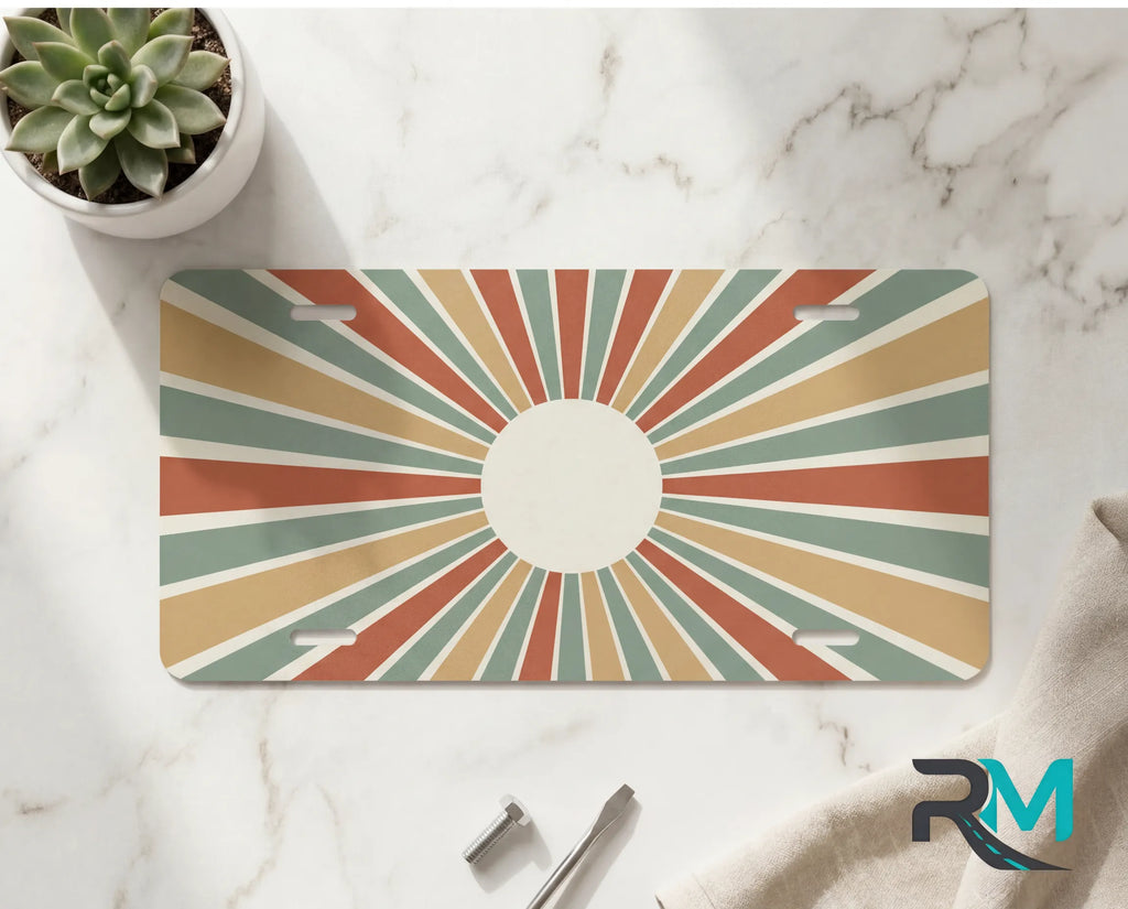 vintage rays vanity plate on marble surface — muted rust mustard decorative license plate