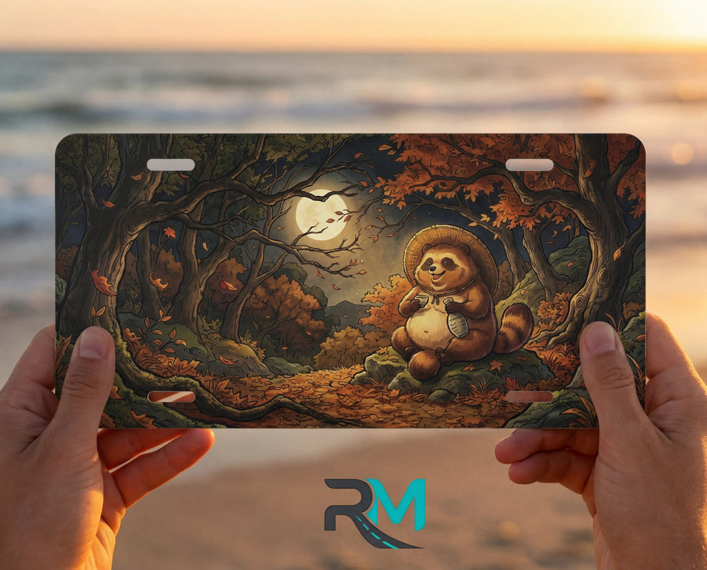 person showing woodland tanuki moonlit forest vanity plate — smiling tanuki amber moonlit autumn front license plate