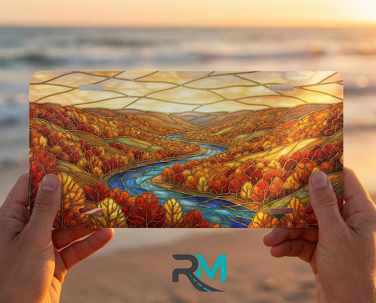 person showing autumn river landscape vanity plate — rich autumn red gold winding river front license plate