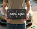 person holding mother of mayhem license plate — gothic skull rose vanity plate art