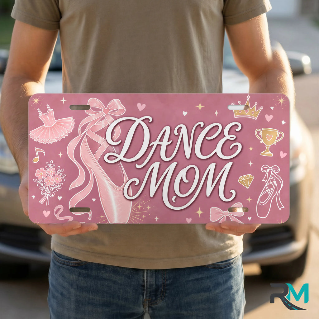 person holding dance mom license plate — soft rose ballet slipper DANCE MOM vanity plate