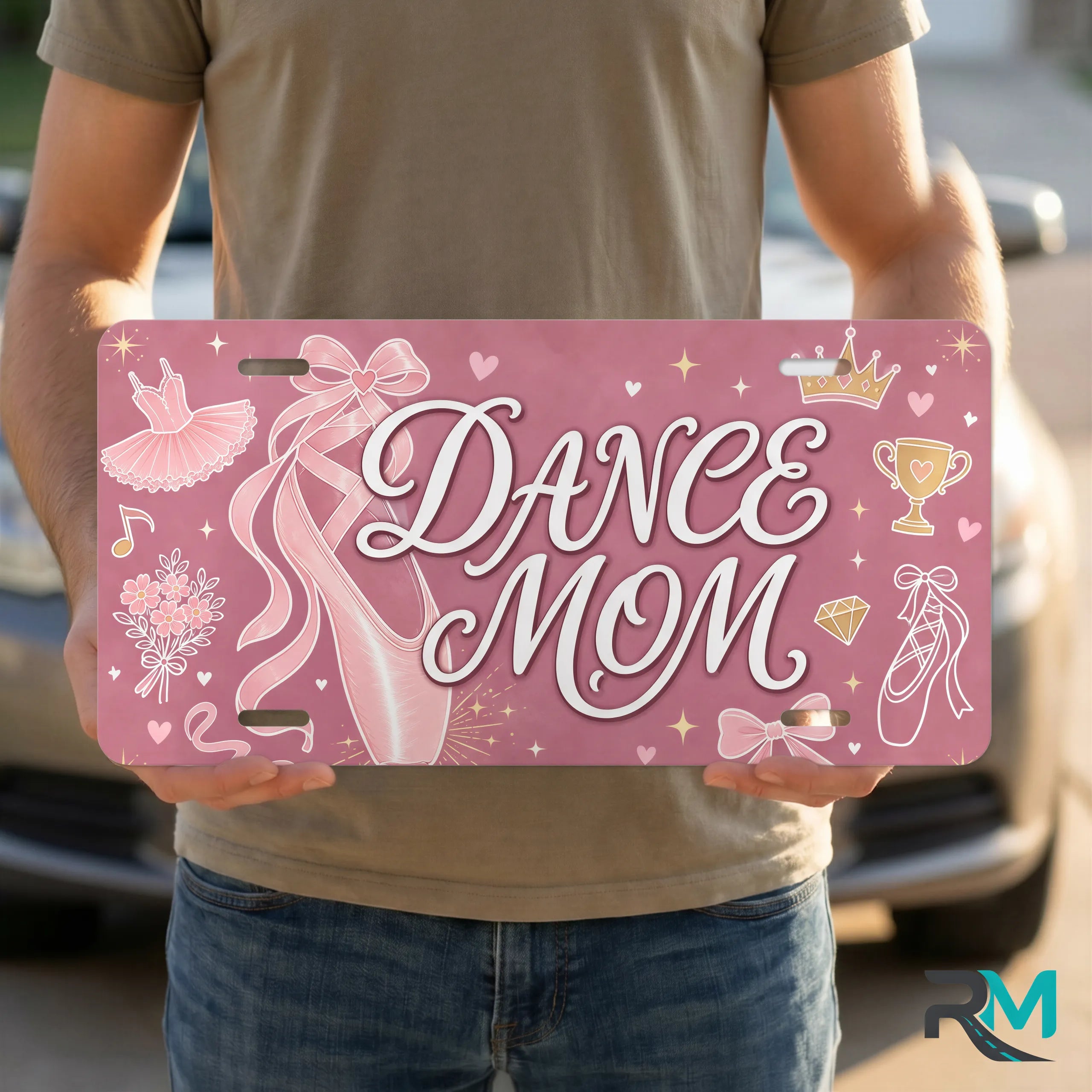person holding dance mom license plate — soft rose ballet slipper DANCE MOM vanity plate