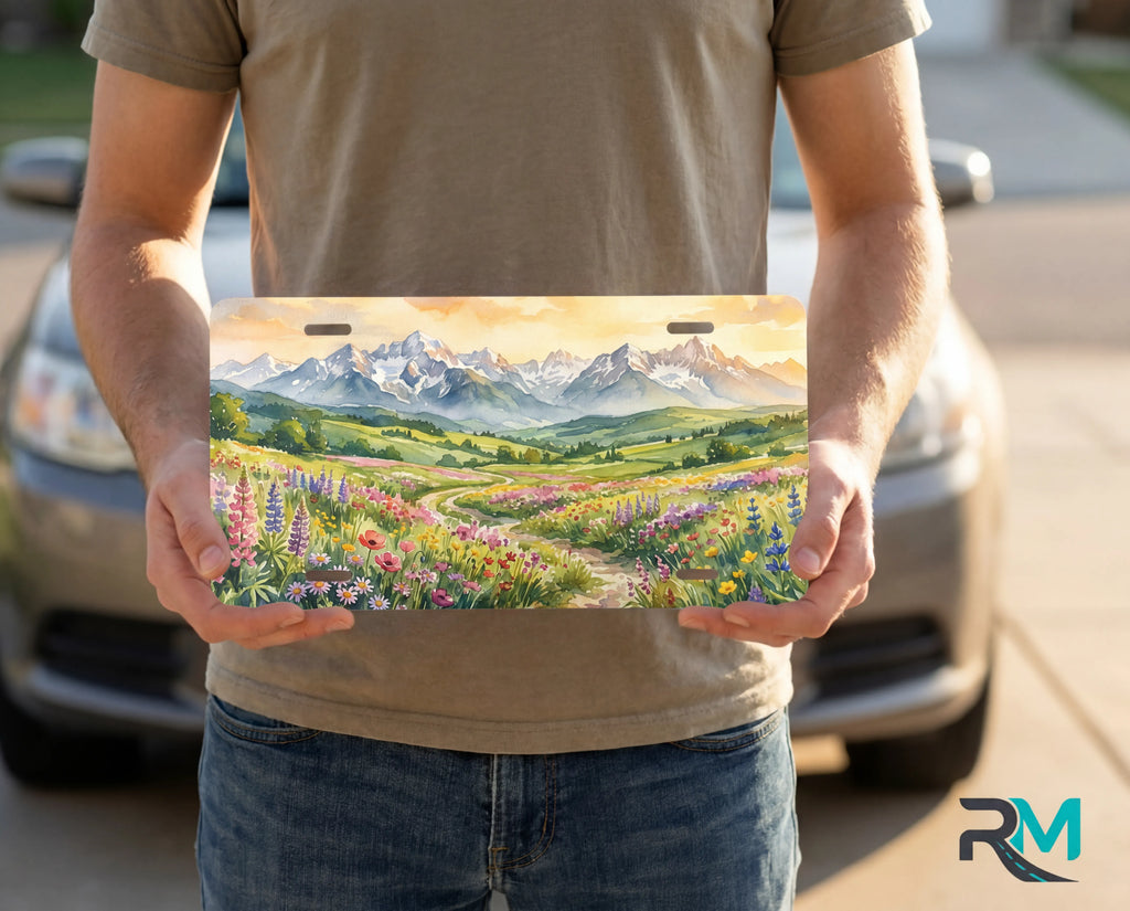 person holding wildflower mountain license plate — decorative alpine meadow vanity plate
