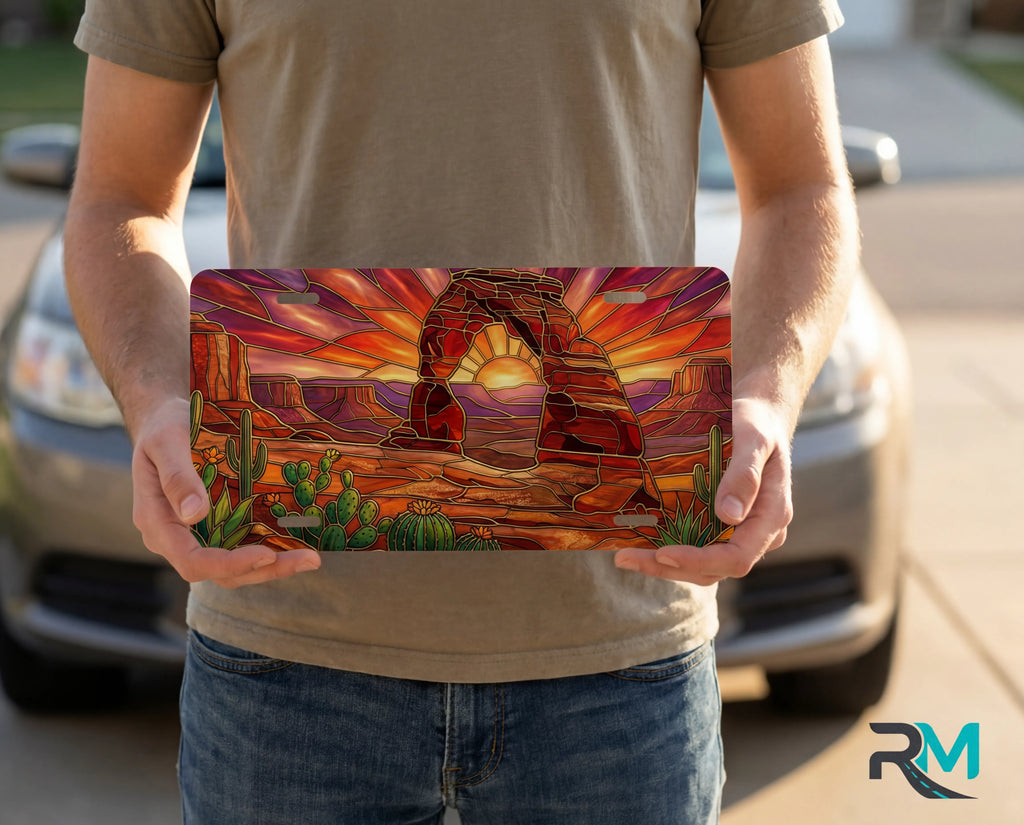 desert arch sunset vanity plate on display stand — warm amber sandstone arch cactus aluminum plate