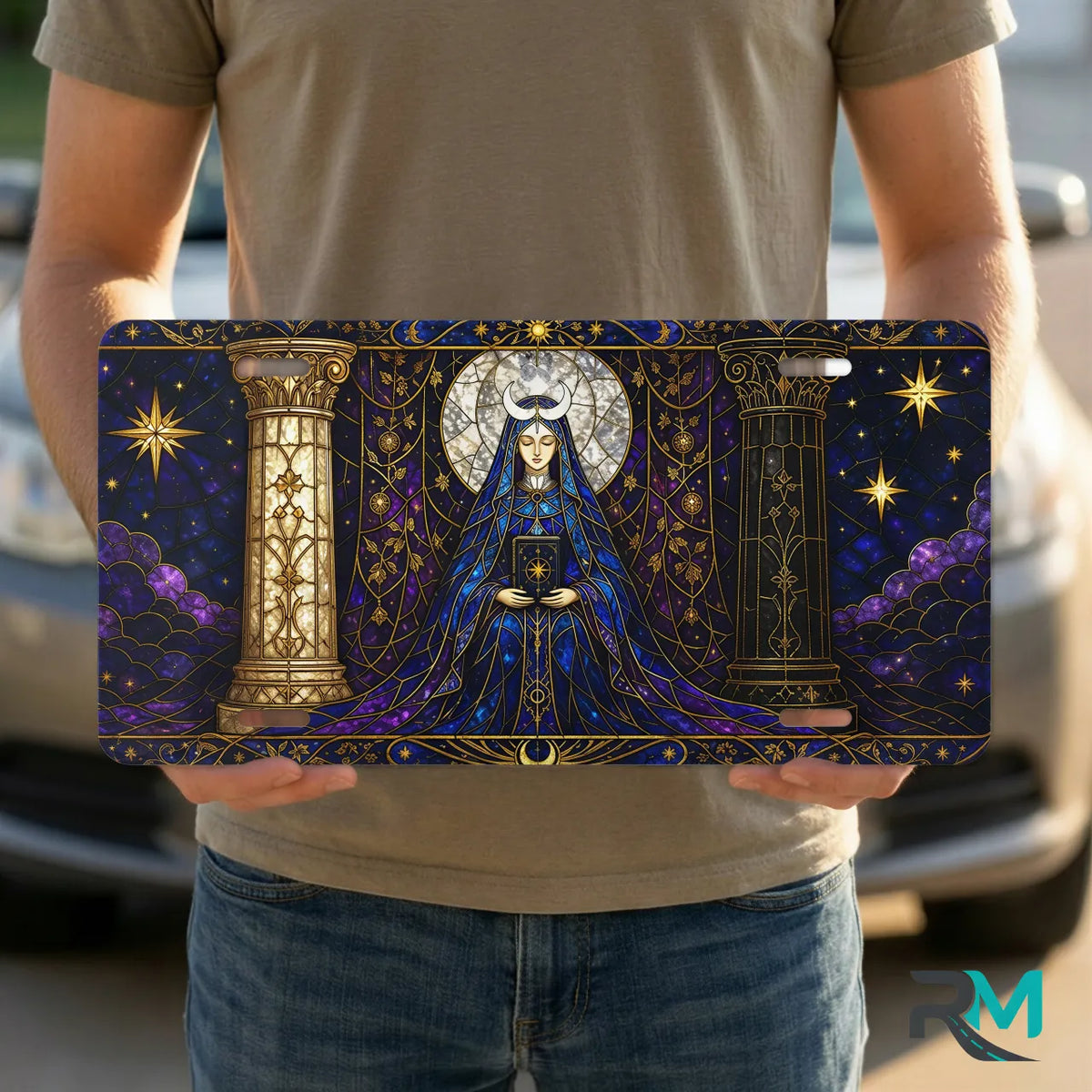 person holding mystic oracle vanity plate — deep indigo gold robed figure front license plate