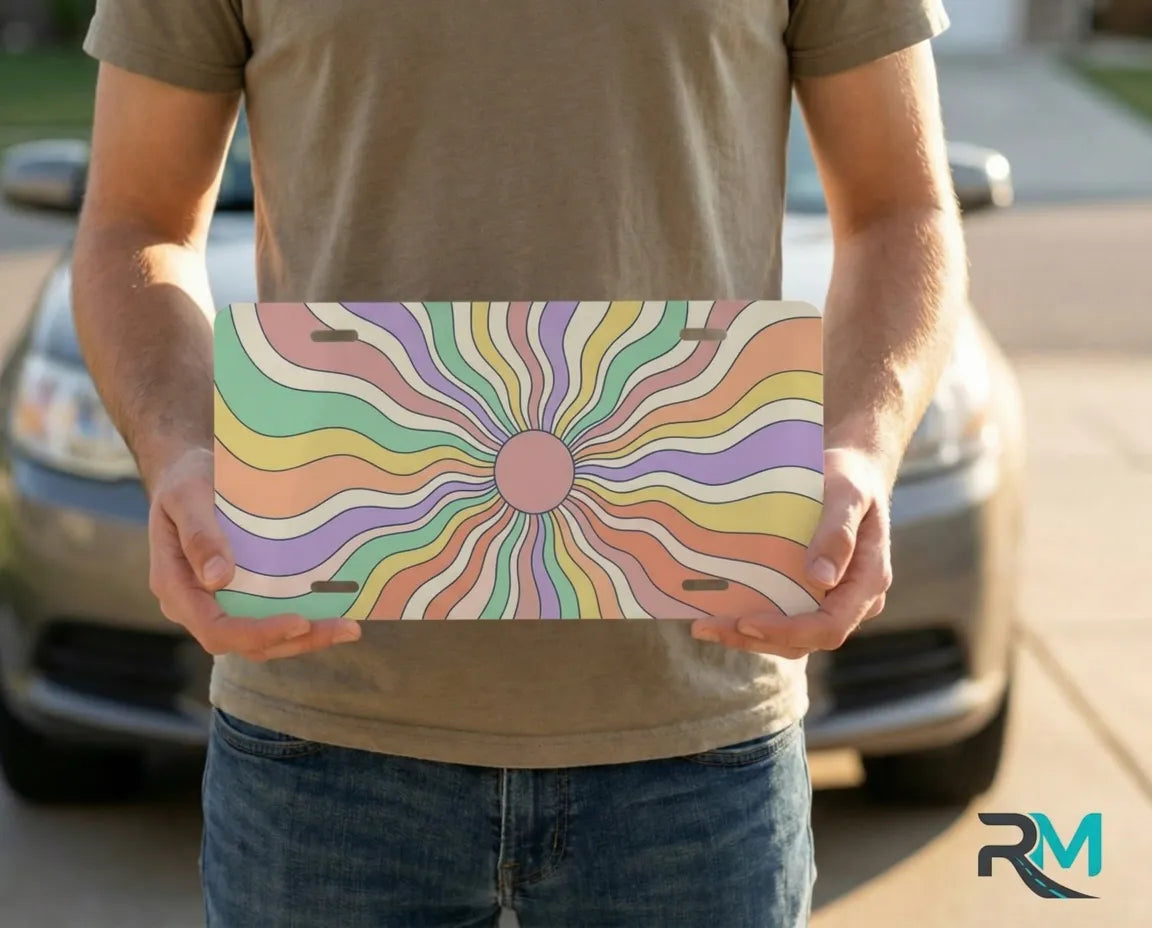 person holding retro pastel rainbow license plate — candy swirl sunburst vanity plate art