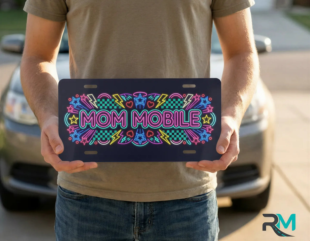 person holding mom mobile license plate — neon retro vanity plate art