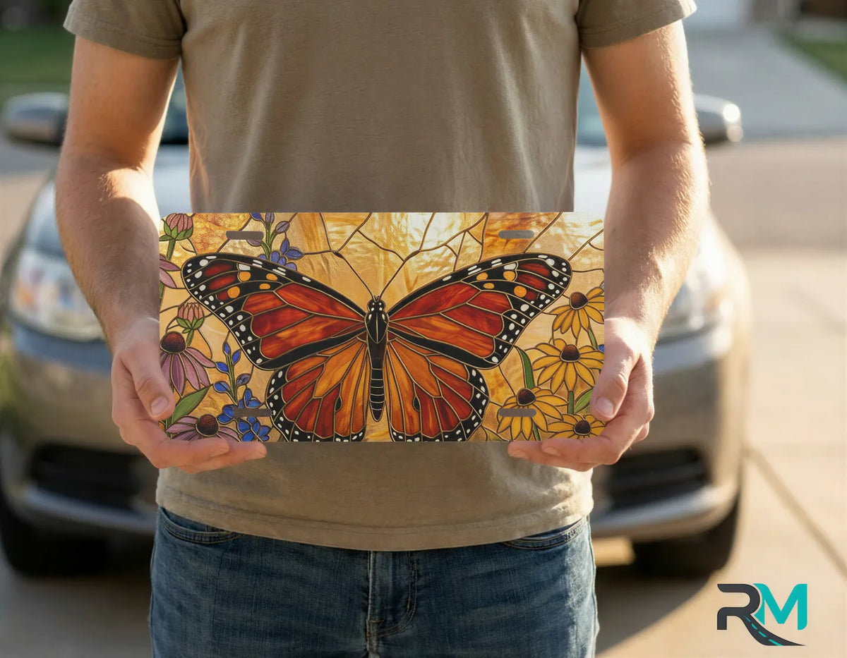 person holding monarch butterfly floral license plate — vivid wildflower meadow vanity plate art