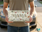 person holding mom life license plate — simple clean custom vanity plate design