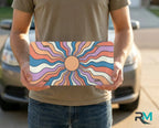 person holding retro sunburst license plate — colorful boho vanity plate summer art