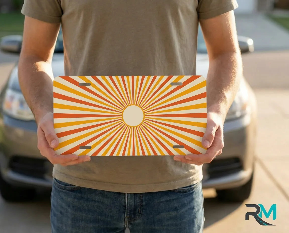 person holding retro orange sunburst license plate — golden peach radiant vanity plate art