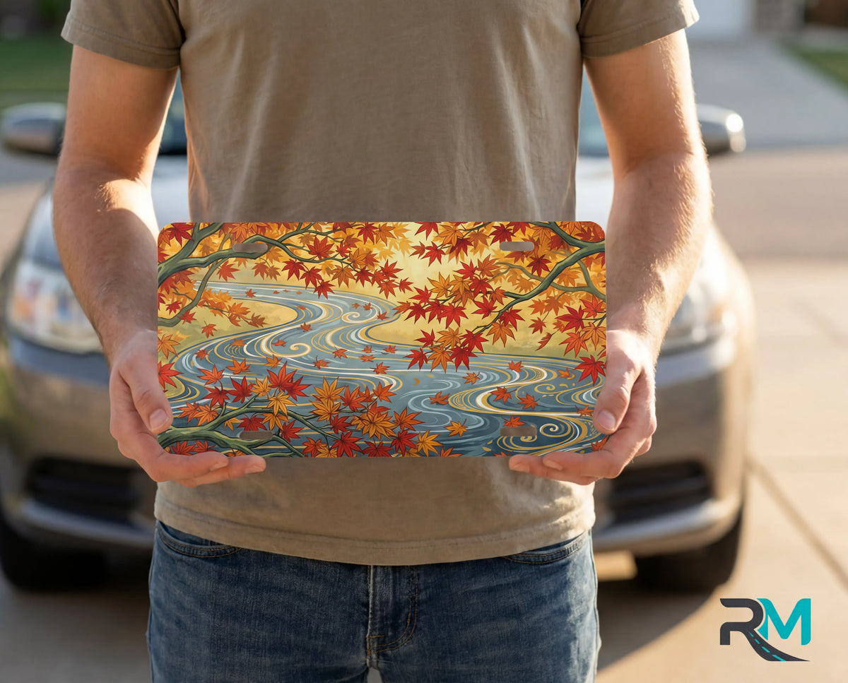autumn maple stream vanity plate on display stand — warm orange gold maple leaves river aluminum plate