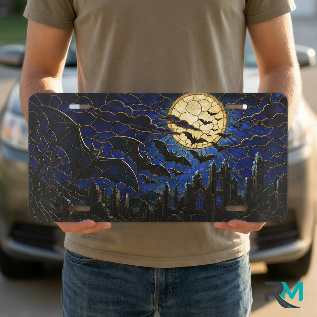 person holding full moon bats vanity plate — midnight blue bat silhouette cracked moon front plate