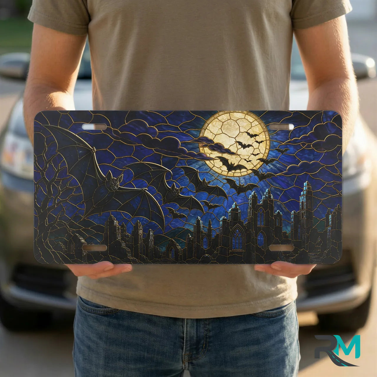 person holding full moon bats vanity plate — midnight blue bat silhouette cracked moon front plate