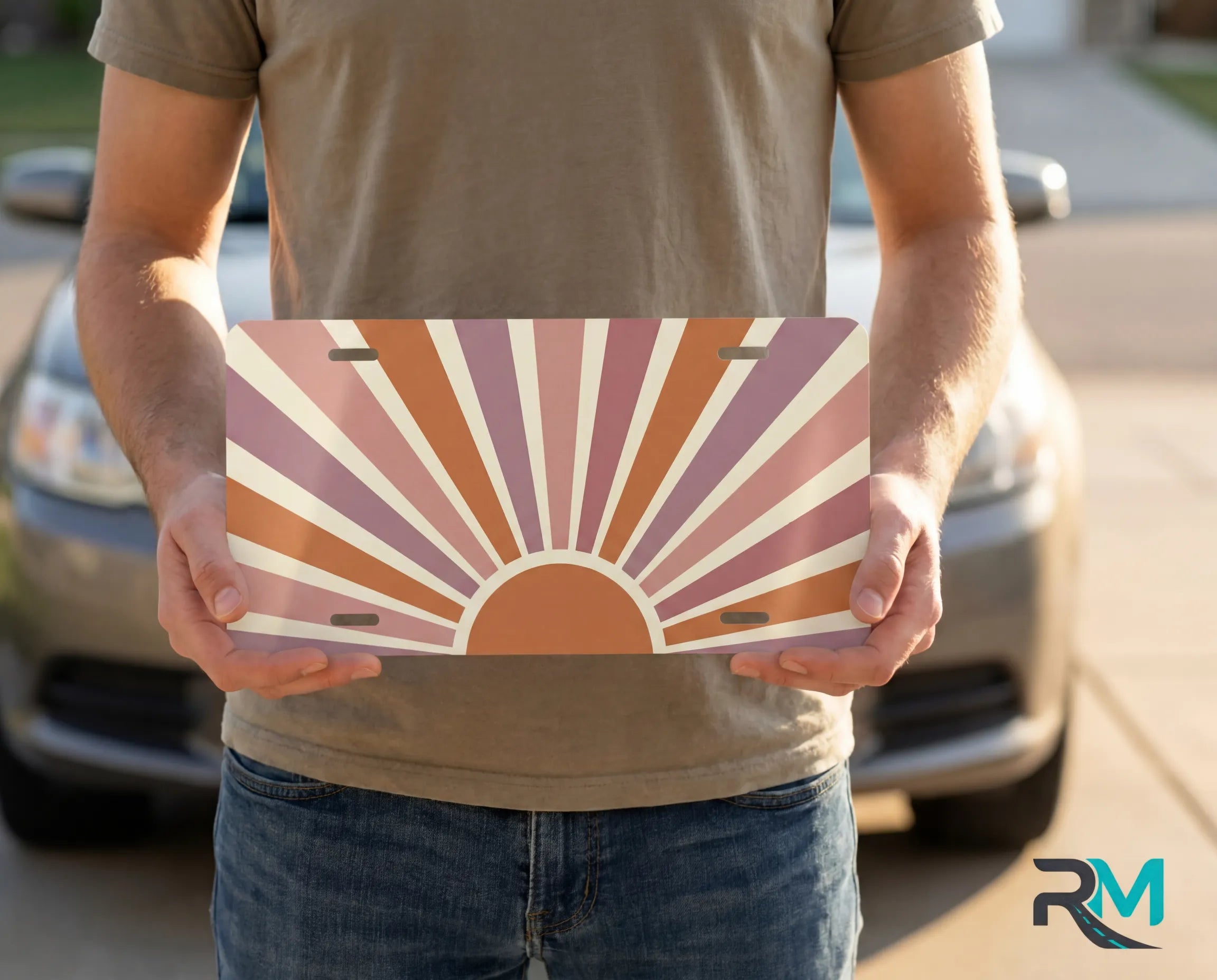 person holding retro terracotta sunrise license plate — muted rose cream vanity plate art
