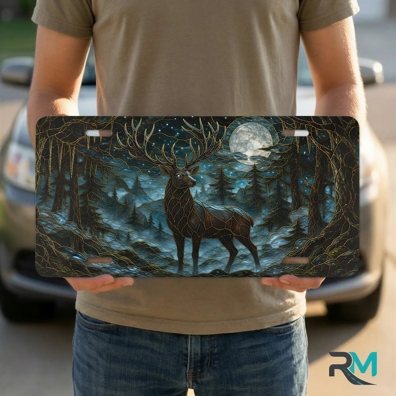 person holding moonlit stag vanity plate — deep teal ink blue stag forest front license plate